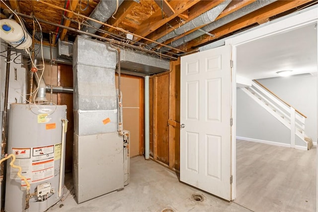 unfinished basement with gas water heater and stairway