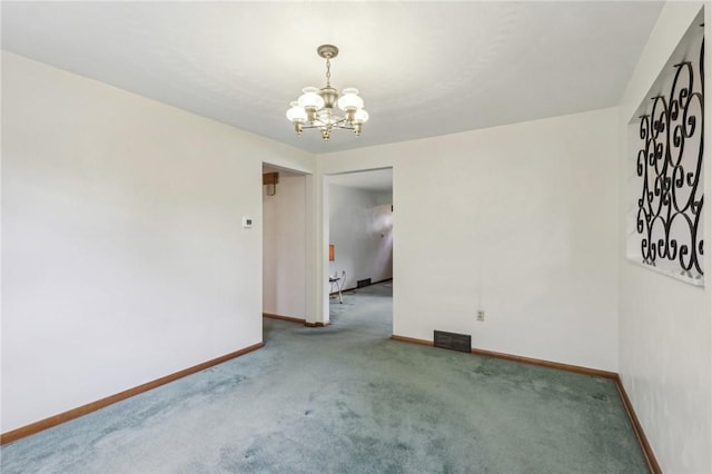 carpeted empty room featuring a notable chandelier, visible vents, and baseboards