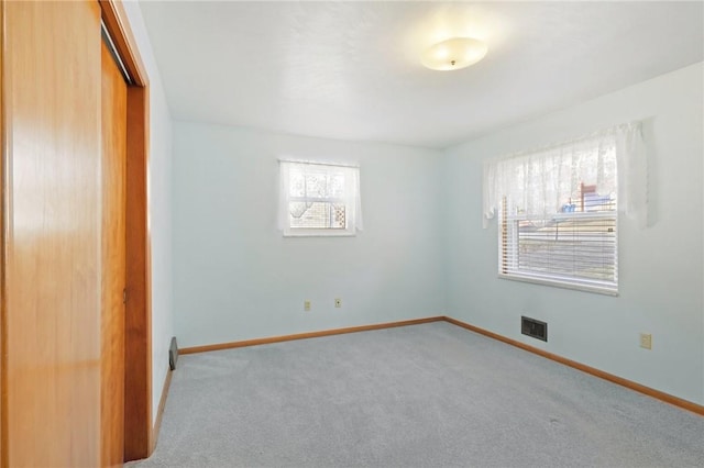 unfurnished bedroom with visible vents, baseboards, a closet, and carpet flooring