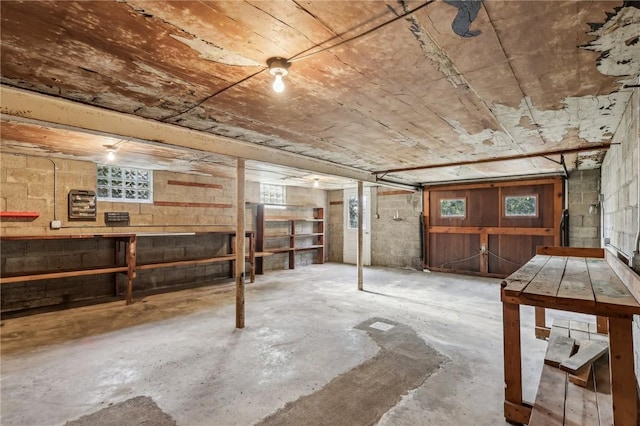 basement featuring a wealth of natural light and concrete block wall