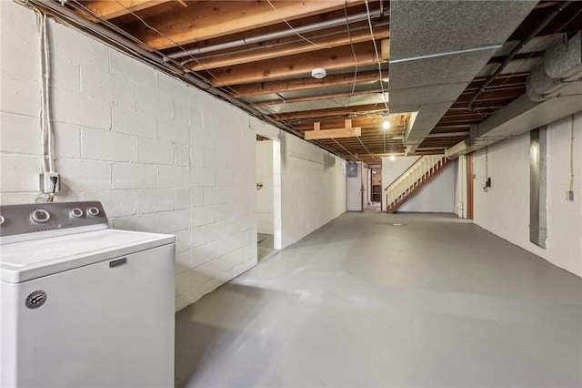 unfinished below grade area with stairway and washer / dryer