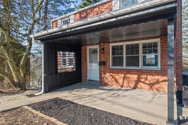 property entrance featuring brick siding and board and batten siding