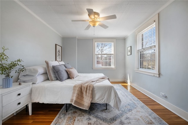 bedroom with baseboards, dark wood finished floors, and crown molding