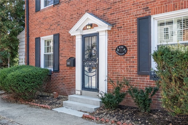 entrance to property with brick siding