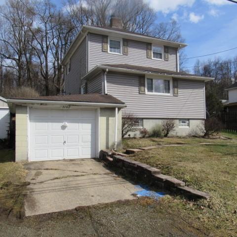 view of property exterior featuring a lawn, concrete driveway, and a chimney