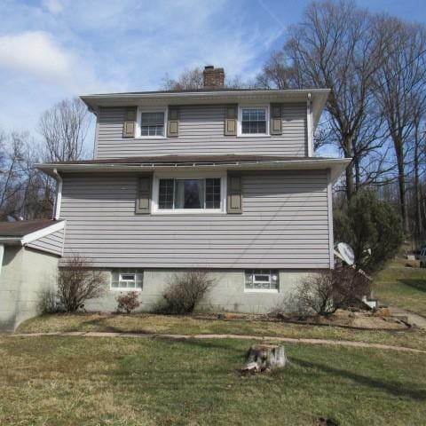 view of home's exterior with a lawn and a chimney