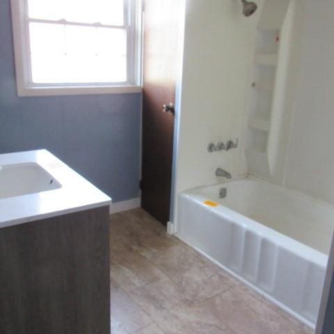 full bathroom featuring vanity, tub / shower combination, and baseboards