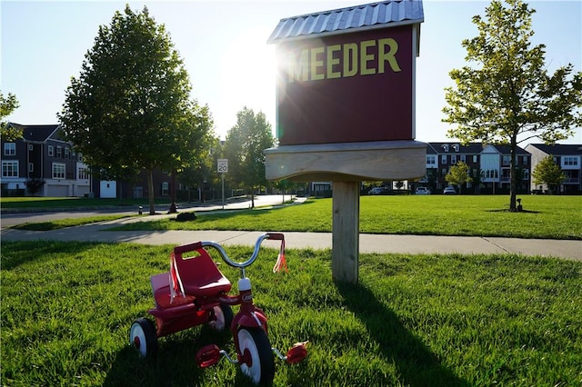 view of property's community with a residential view and a lawn