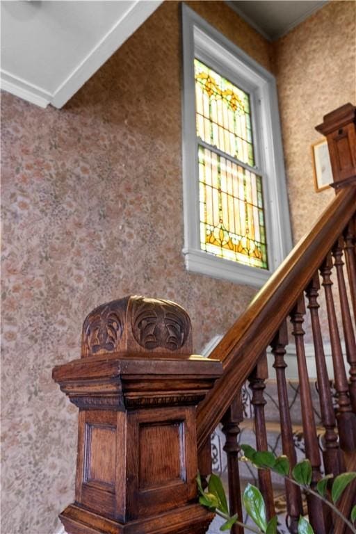 stairs featuring wallpapered walls