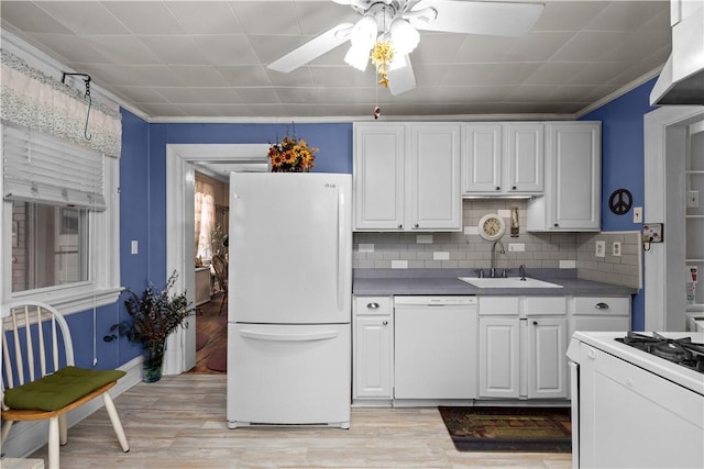 kitchen featuring crown molding, white appliances, light wood-type flooring, and a sink