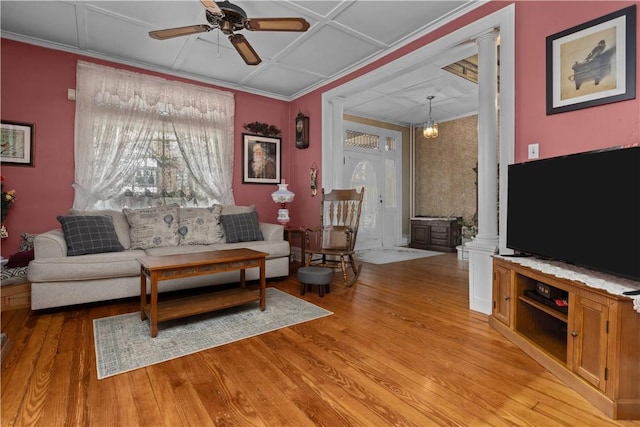 living area with ornamental molding, light wood-style flooring, decorative columns, and ceiling fan