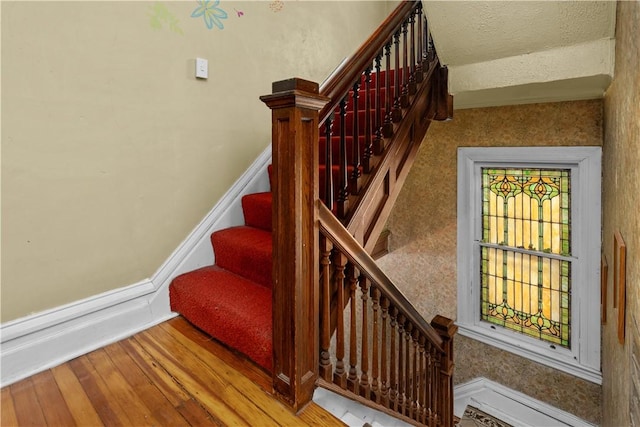 stairs featuring baseboards and wood finished floors