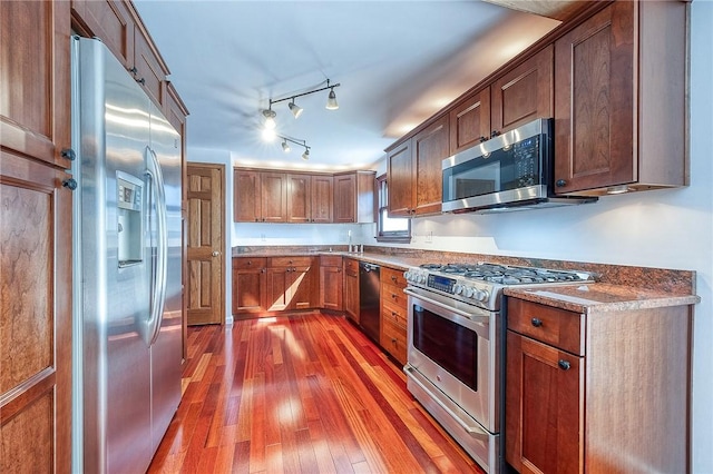 kitchen with a sink, hardwood / wood-style flooring, and stainless steel appliances