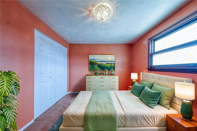 bedroom featuring carpet, a closet, and baseboards