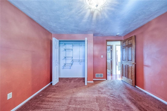 unfurnished bedroom featuring baseboards, visible vents, and carpet floors