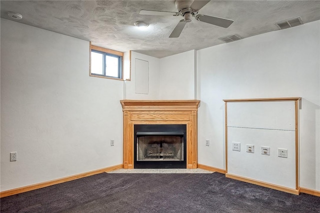 unfurnished living room featuring carpet flooring, a fireplace with flush hearth, baseboards, and visible vents