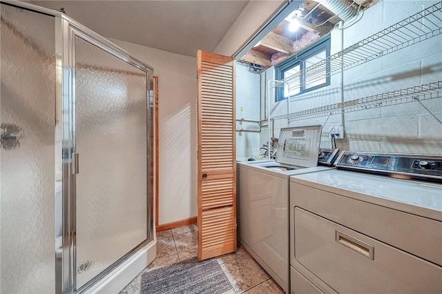 washroom with light tile patterned floors and washing machine and clothes dryer