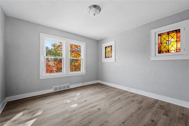 47 Bellanca Ave, Brentwood, PA 15227 - unfurnished room featuring visible vents, baseboards, a textured ceiling, and wood finished floors