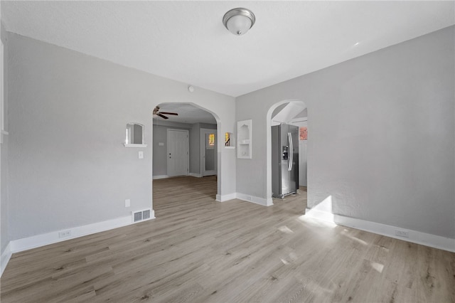 47 Bellanca Ave, Brentwood, PA 15227 - unfurnished room with visible vents, baseboards, ceiling fan, light wood-style flooring, and arched walkways