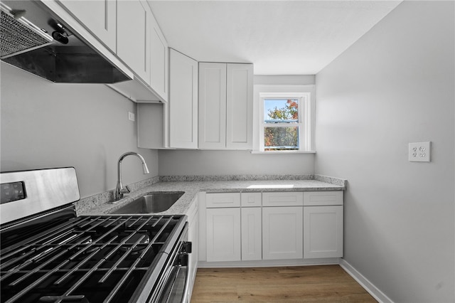 47 Bellanca Ave, Brentwood, PA 15227 - kitchen with under cabinet range hood, gas range, white cabinets, and a sink