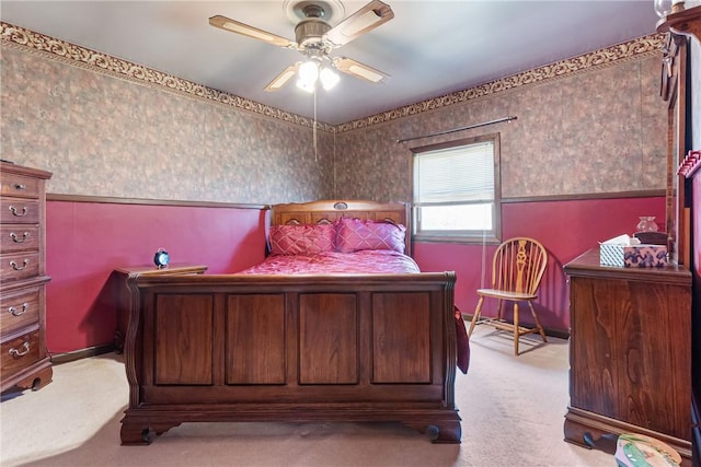 bedroom featuring light colored carpet and a ceiling fan