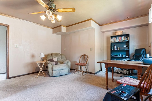 carpeted home office with baseboards, crown molding, and a ceiling fan