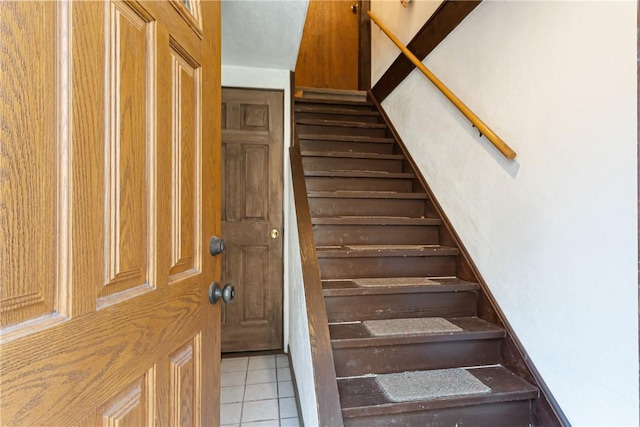 stairs featuring tile patterned flooring