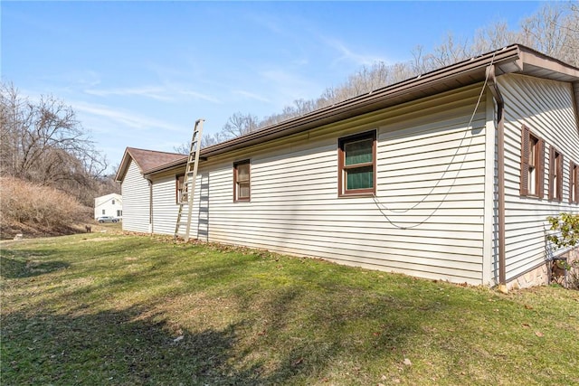 view of property exterior featuring a lawn