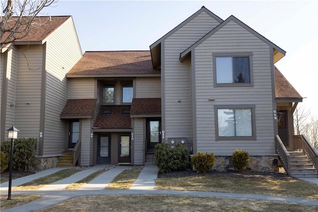 multi unit property featuring a shingled roof