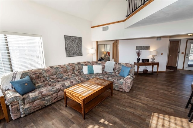 living room featuring visible vents, plenty of natural light, and wood finished floors