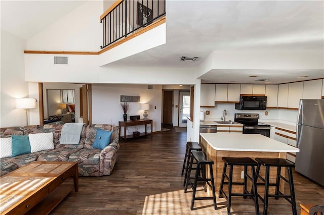 kitchen with open floor plan, appliances with stainless steel finishes, visible vents, and a sink