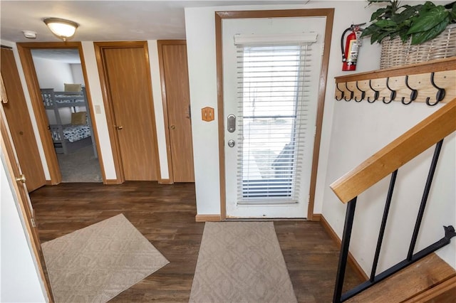 doorway to outside featuring stairs, wood finished floors, and baseboards