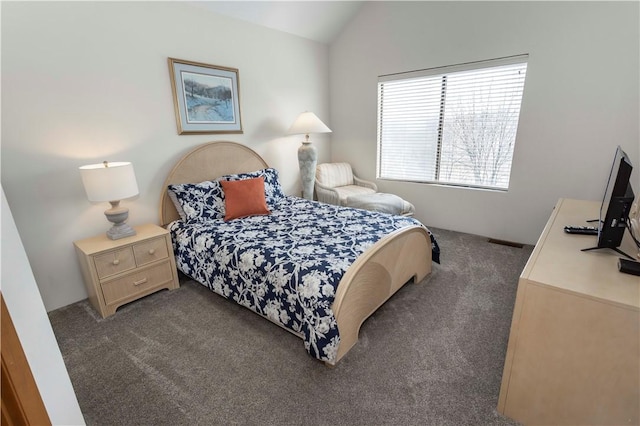 bedroom featuring visible vents, lofted ceiling, and carpet floors