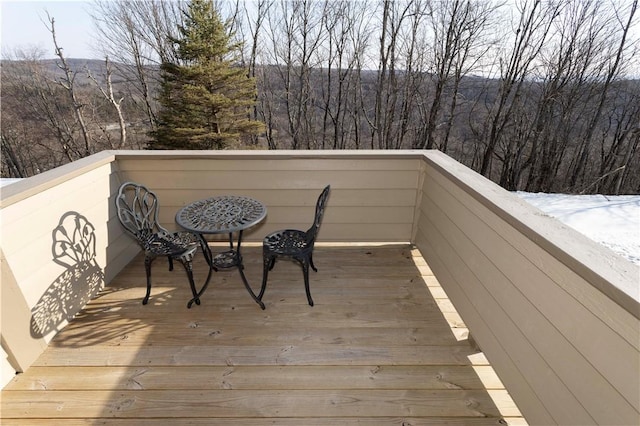 wooden terrace featuring a forest view