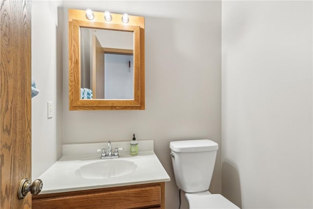 bathroom with toilet and vanity