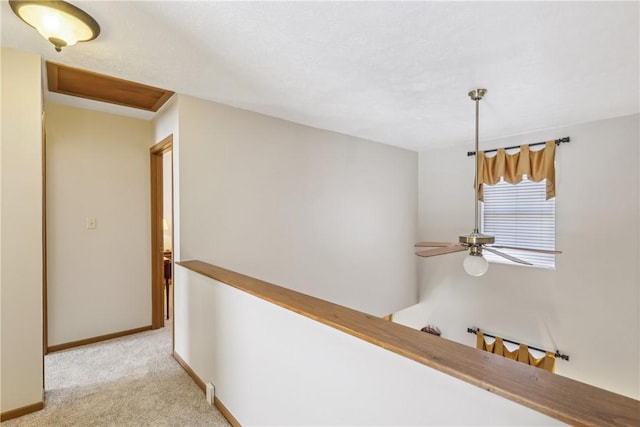 hallway with baseboards and carpet floors