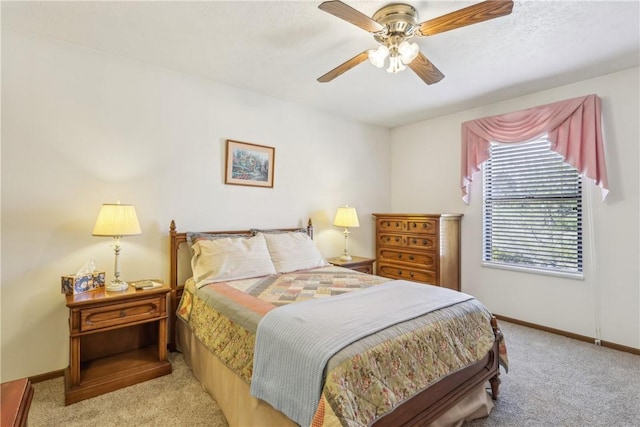 bedroom featuring carpet flooring, a ceiling fan, and baseboards