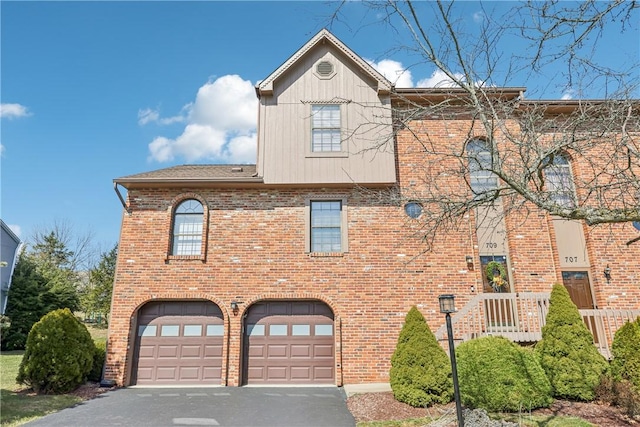 view of front of house with brick siding, driveway, and an attached garage