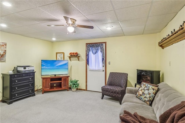 living room with carpet flooring, a drop ceiling, and ceiling fan