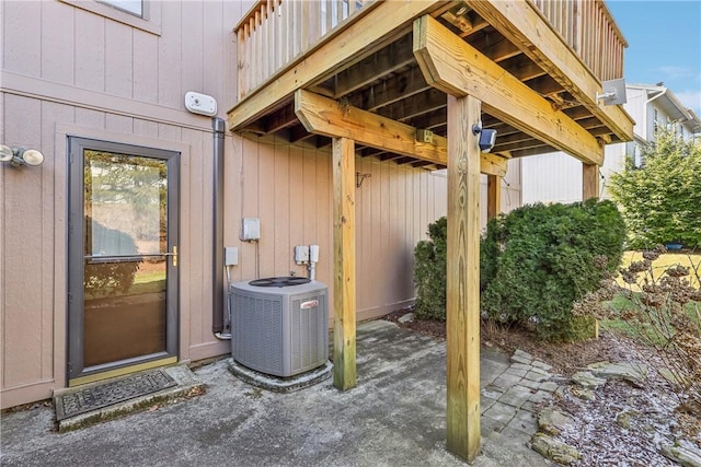 doorway to property with a patio area and central AC unit