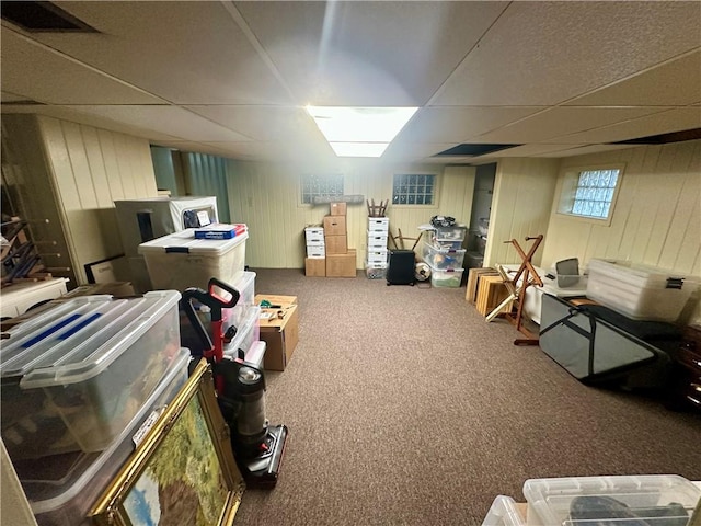 below grade area featuring carpet flooring and a drop ceiling