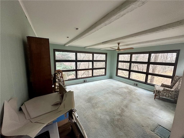 unfurnished sunroom with beam ceiling