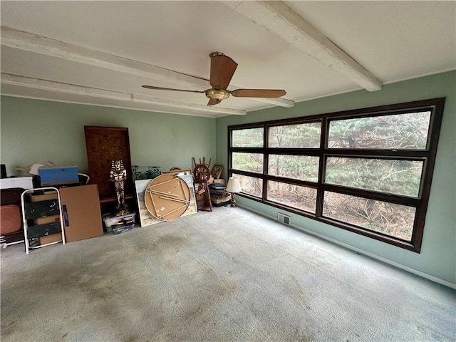 sunroom / solarium with beamed ceiling and ceiling fan