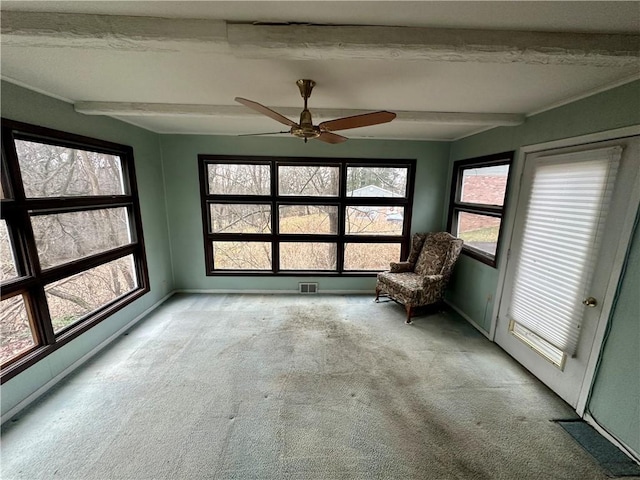 unfurnished sunroom featuring beamed ceiling, ceiling fan, and visible vents