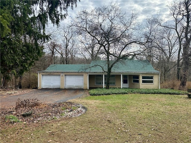 ranch-style house with brick siding, driveway, a front lawn, and a garage