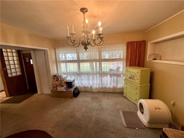 dining room featuring a chandelier and carpet floors