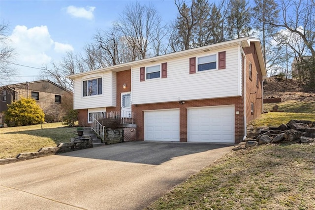 split foyer home with aphalt driveway, an attached garage, and brick siding