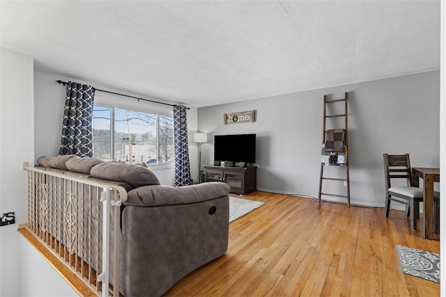 living room with baseboards and hardwood / wood-style floors