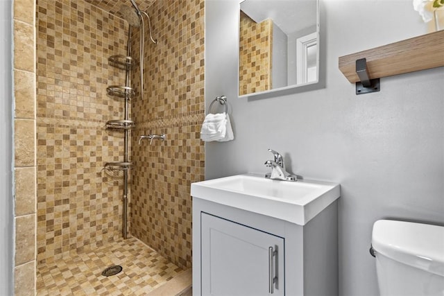 full bathroom with toilet, a stall shower, and vanity