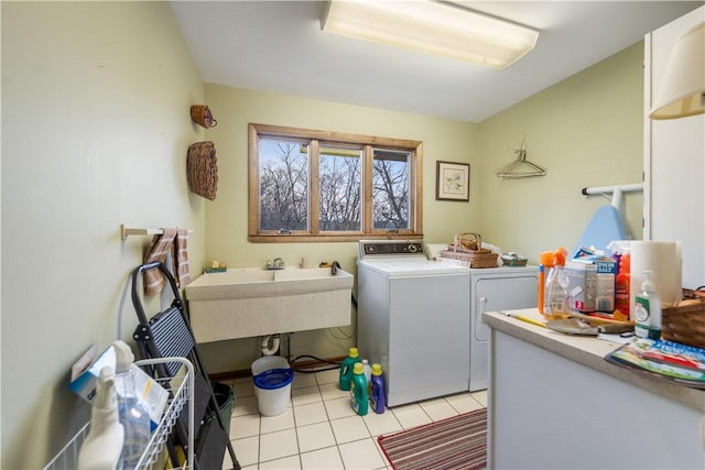 washroom featuring light tile patterned floors, laundry area, and independent washer and dryer